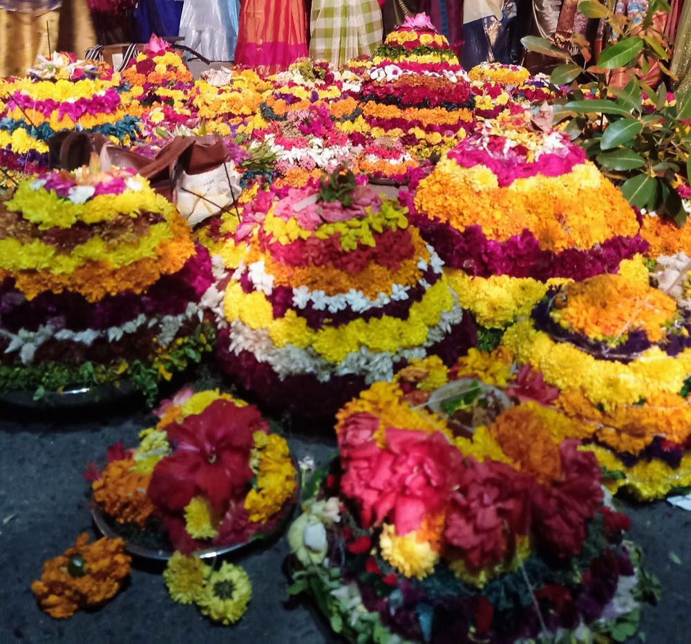Conical Bathukamma flower stacks made of seasonal blooms, Telangana's flower festival