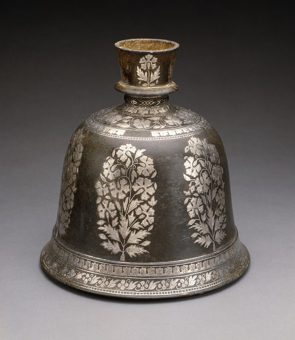 A blackened Bidriware hookah base inlaid with silver floral patterns, a Hyderabad metal craft