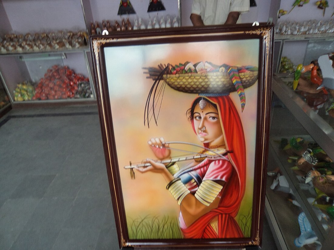 A golden-hued Nirmal painting in a lacquered frame, a centuries-old craft from Nirmal, Telangana