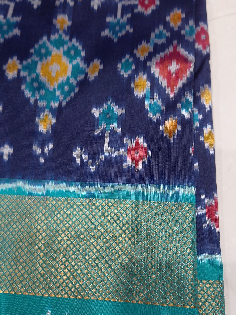 A brightly patterned Pochampally ikat silk saree with geometric tie-dye motifs, Telangana