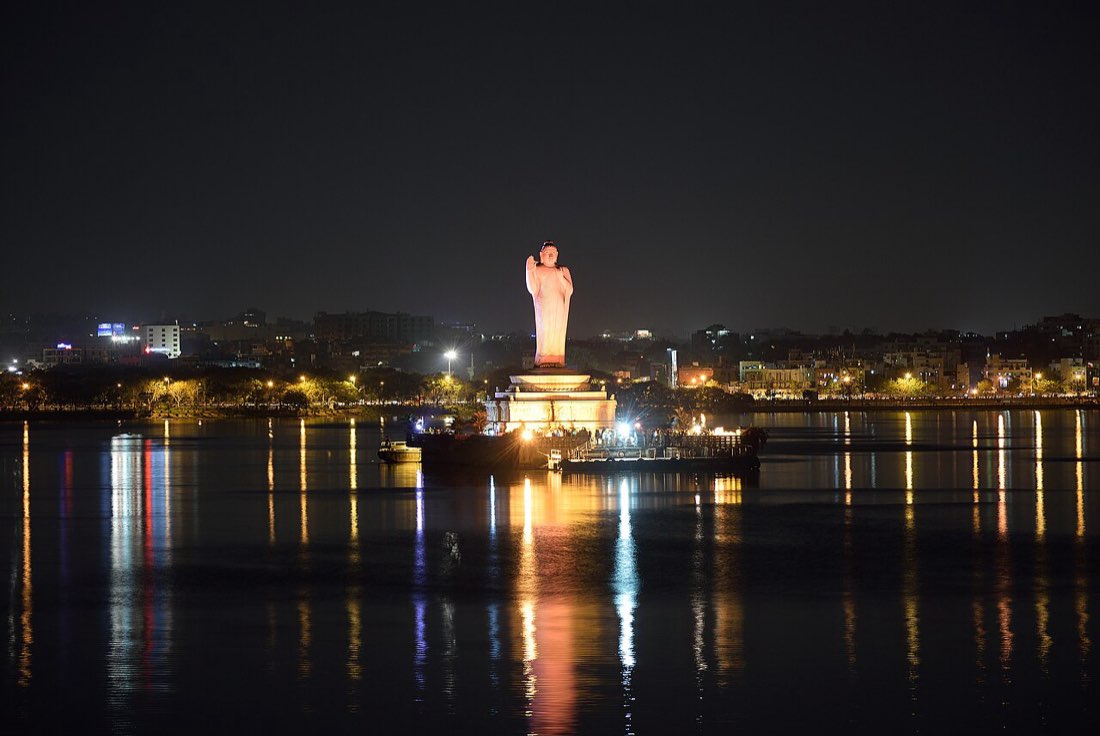 The illuminated Buddha statue on Hussain Sagar lake, Hyderabad, at night