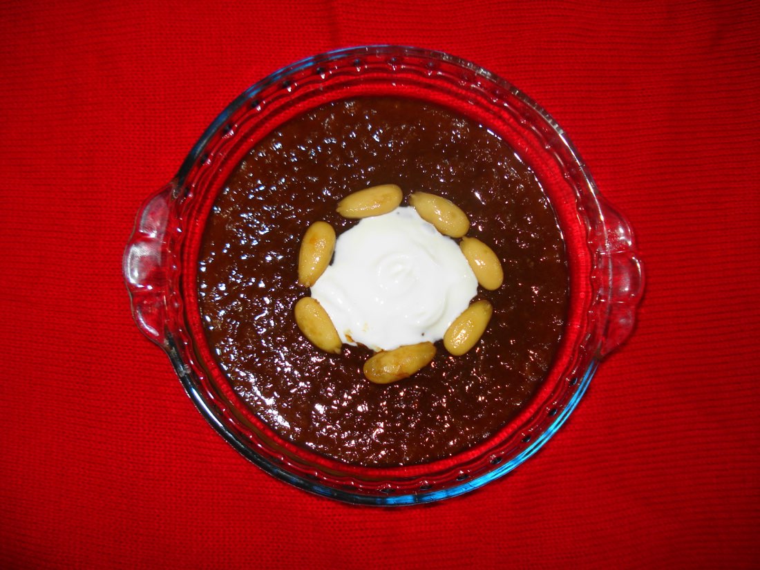 Qubani ka meetha, a Hyderabadi stewed-apricot dessert topped with cream